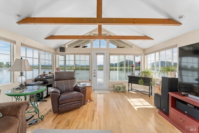 sunroom featuring lofted ceiling with beams, plenty of natural light, and a water view