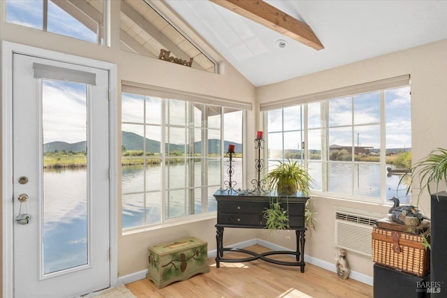 sunroom / solarium with a water view and lofted ceiling with beams