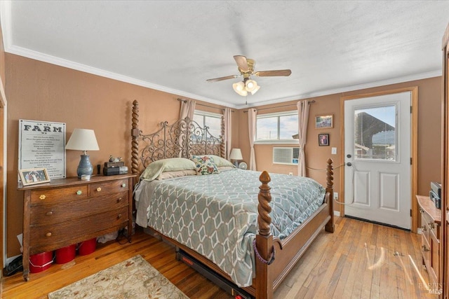 bedroom featuring crown molding, ceiling fan, and light hardwood / wood-style floors