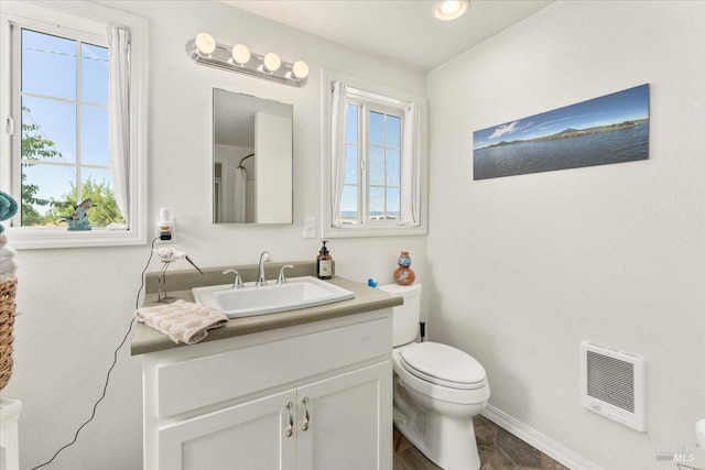 bathroom with vanity, tile patterned flooring, and toilet