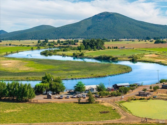 view of home's community with a water and mountain view and a rural view