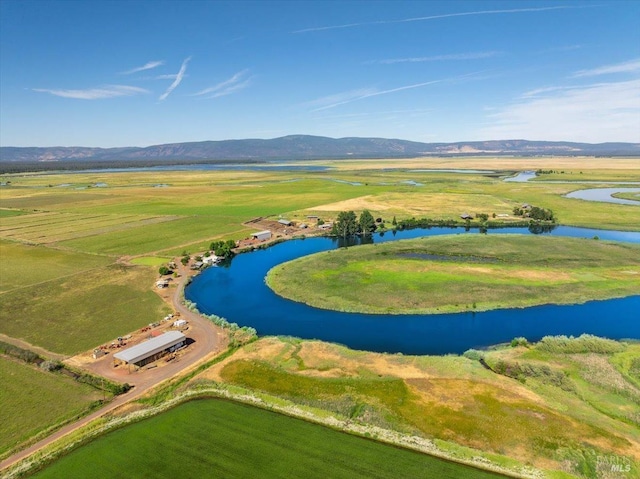 aerial view with a water and mountain view and a rural view