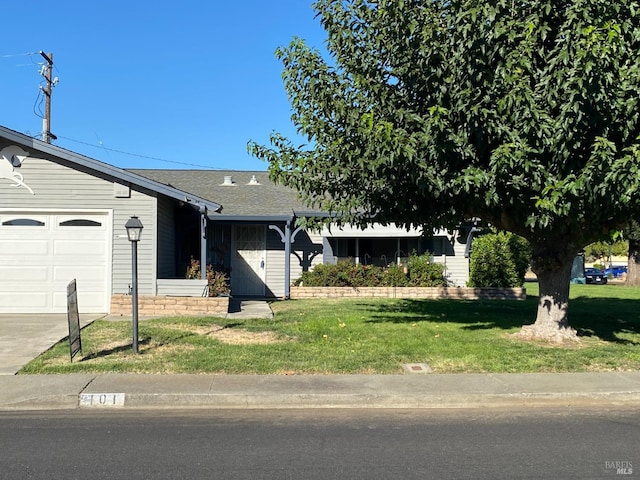 ranch-style home featuring a front yard and a garage