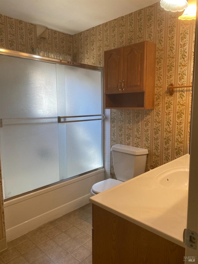 bathroom featuring vanity and shower / bath combination with glass door