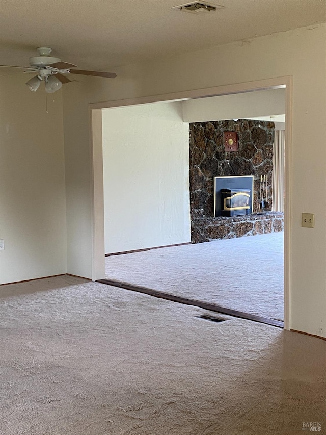 empty room with carpet flooring and ceiling fan