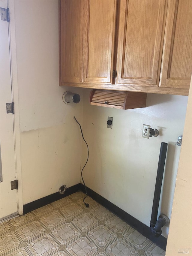 laundry area with cabinets and hookup for an electric dryer