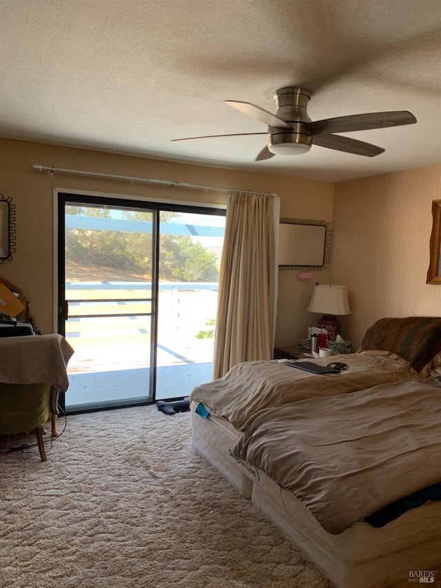 bedroom featuring carpet flooring, ceiling fan, access to exterior, and a textured ceiling