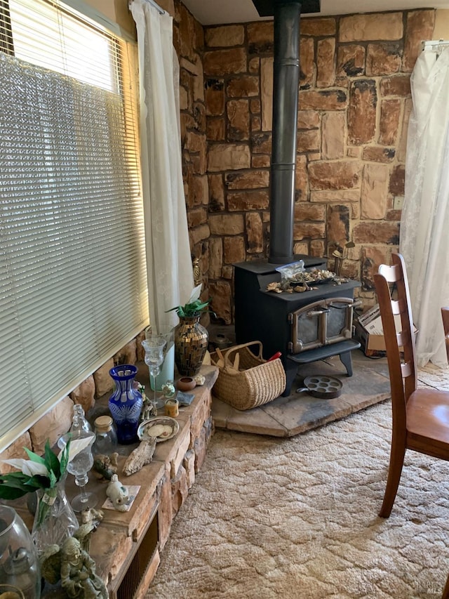 details with carpet flooring and a wood stove