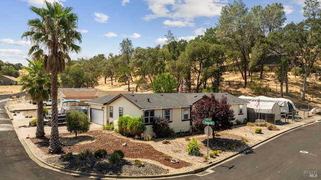 ranch-style house featuring an attached garage and driveway