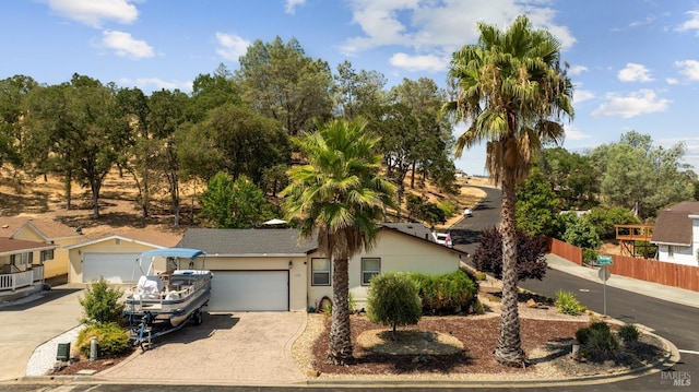 single story home featuring fence, driveway, and stucco siding