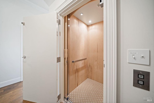 interior space featuring elevator and wood-type flooring