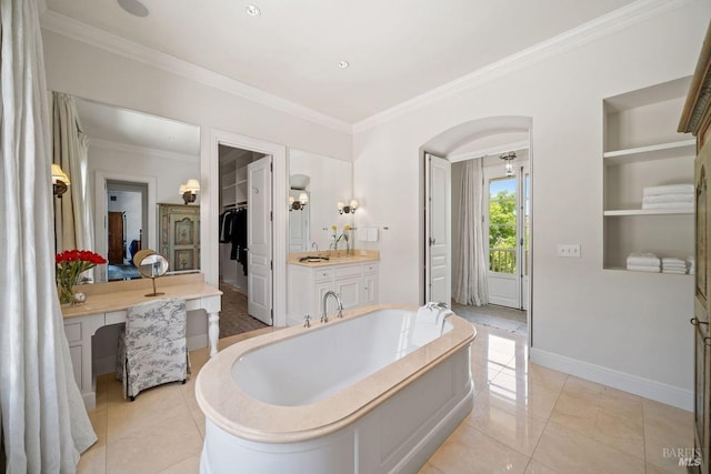 bathroom featuring vanity, a washtub, tile patterned flooring, and crown molding