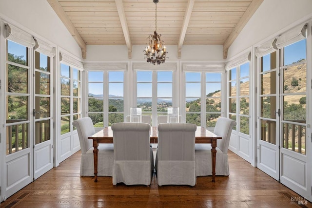 sunroom featuring vaulted ceiling with beams and plenty of natural light