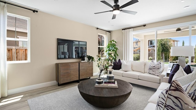 living room with light wood-type flooring and ceiling fan