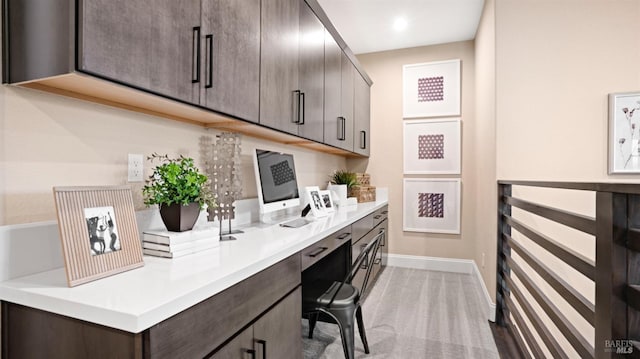 office area featuring light carpet and built in desk