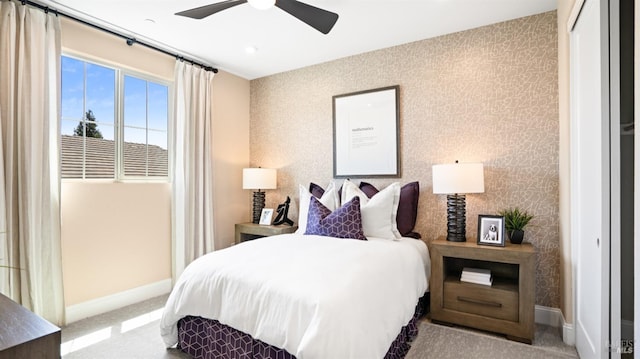 bedroom featuring light colored carpet and ceiling fan