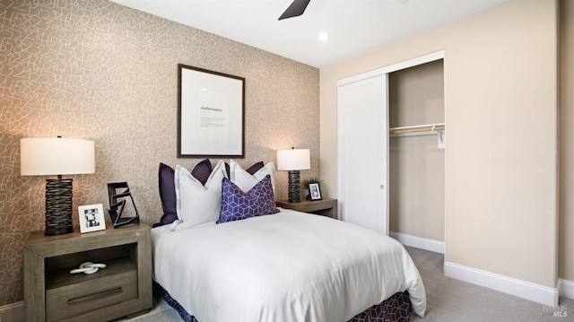 bedroom with ceiling fan, carpet flooring, and a closet