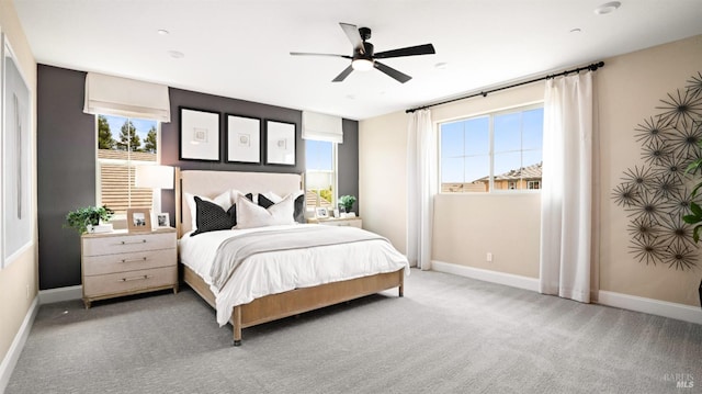 bedroom featuring multiple windows, ceiling fan, and carpet