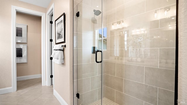 bathroom featuring tile patterned floors and a shower with door