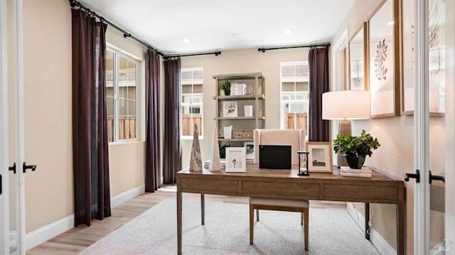 office space featuring french doors and light wood-type flooring