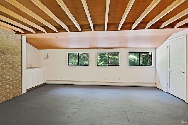 18751 Appian Way, Navarro, CA 95463 - empty room with vaulted ceiling, plenty of natural light, baseboard heating, and brick wall