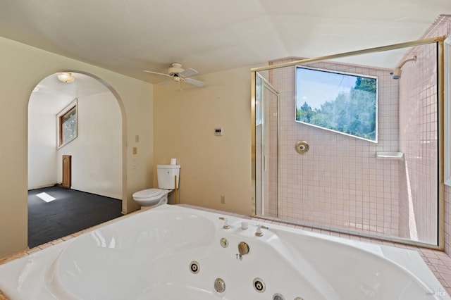 bathroom featuring walk in shower, ceiling fan, and toilet