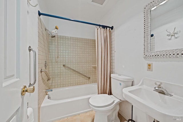 full bathroom featuring toilet, tile patterned floors, shower / bathtub combination with curtain, and sink