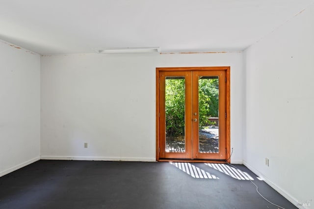 unfurnished room with concrete flooring