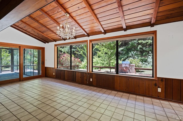 unfurnished sunroom featuring vaulted ceiling with beams, wood ceiling, a wealth of natural light, and an inviting chandelier