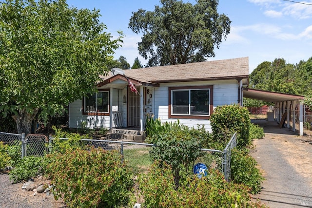 view of front of property featuring driveway, a carport, a gate, and a fenced front yard