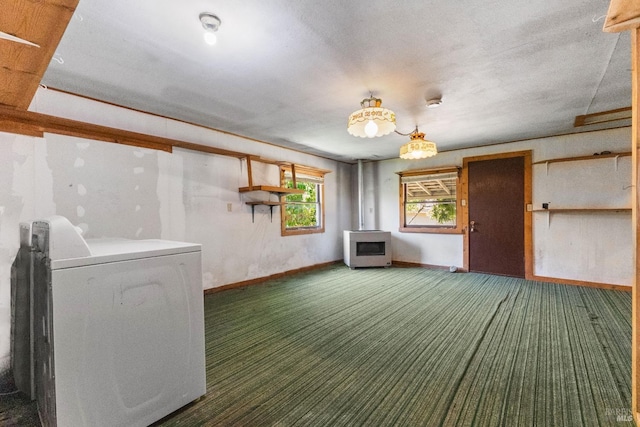 below grade area featuring baseboards, washer / clothes dryer, carpet floors, and a textured ceiling