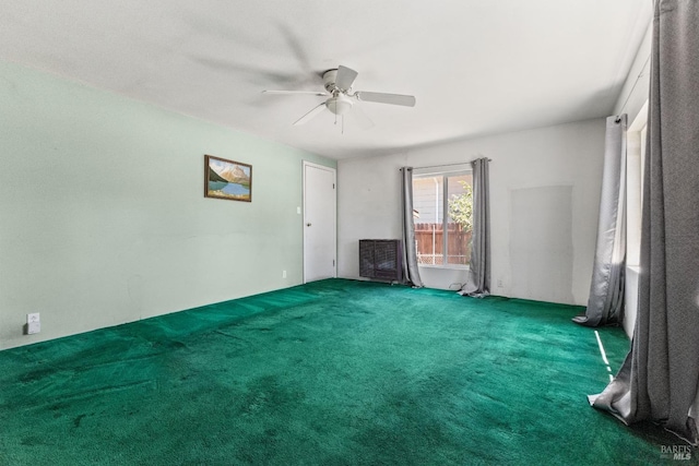 empty room featuring ceiling fan and carpet flooring