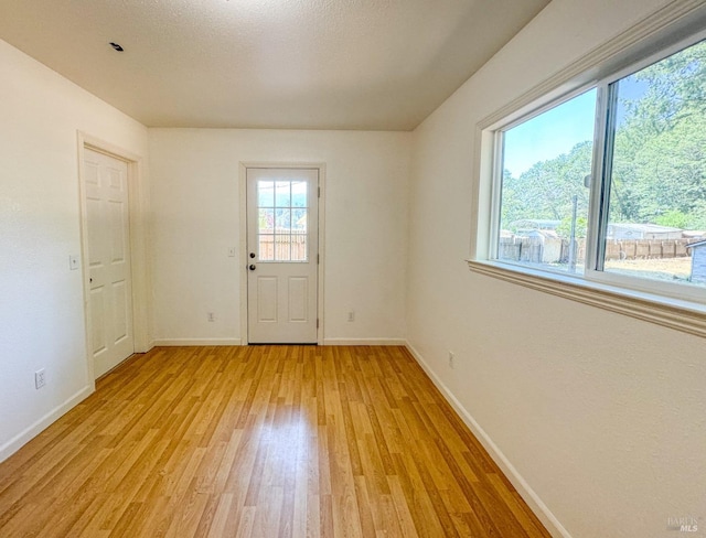 interior space with light wood-style flooring and baseboards