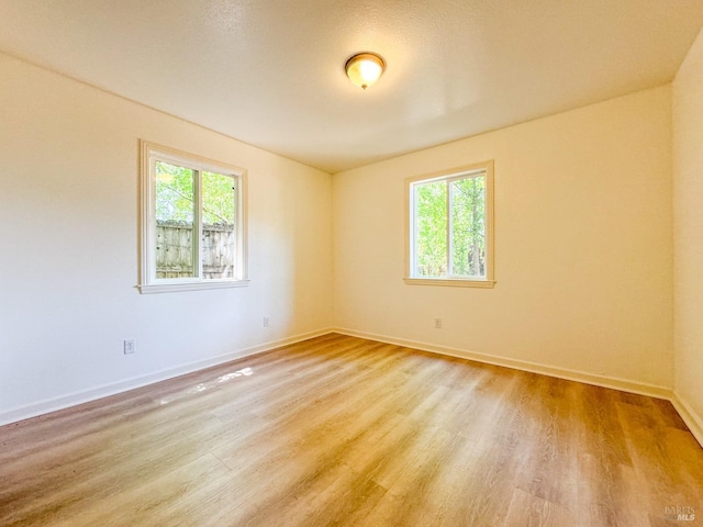 empty room with light hardwood / wood-style floors