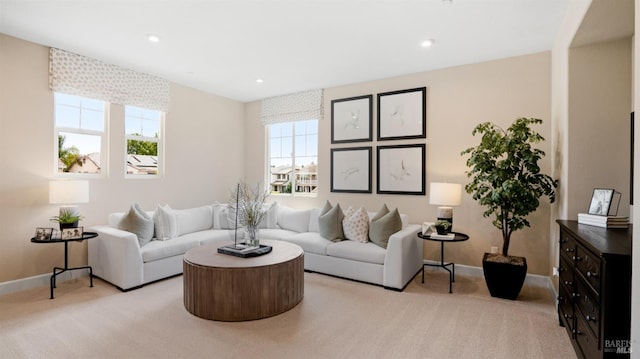 living room featuring light colored carpet and a wealth of natural light