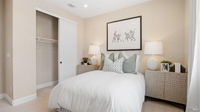 bedroom with light colored carpet and a closet