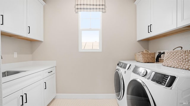 clothes washing area featuring cabinets, independent washer and dryer, and light tile patterned floors