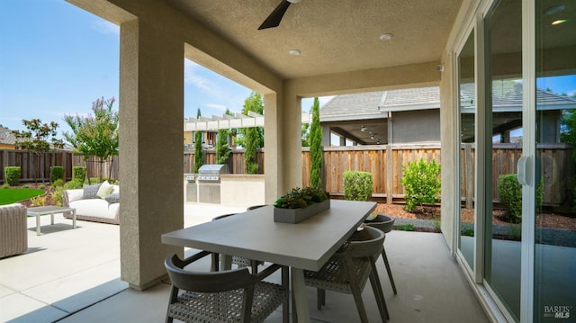 view of patio / terrace with grilling area, ceiling fan, and exterior kitchen