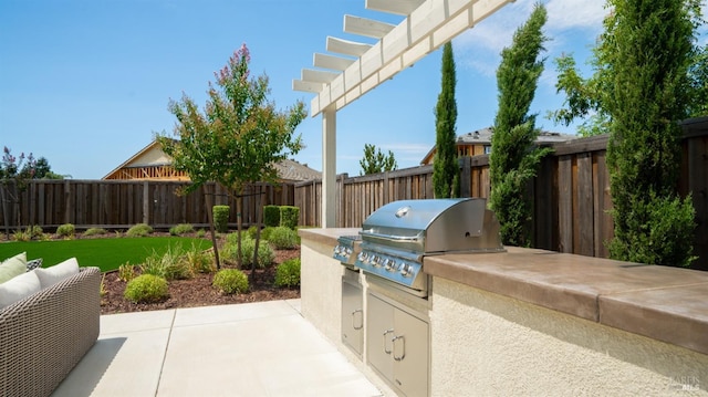 view of patio with an outdoor kitchen, area for grilling, and a pergola