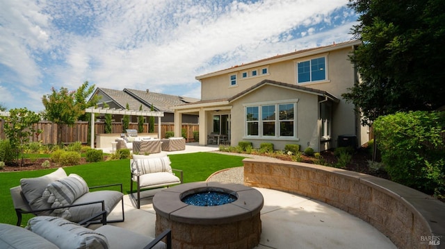 back of house featuring an outdoor bar, a yard, a patio, and a fire pit