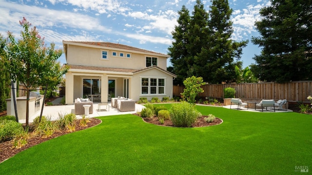 rear view of property featuring an outdoor living space, a yard, and a patio