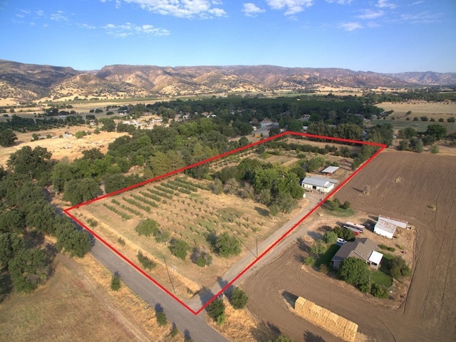 drone / aerial view featuring a mountain view and a rural view