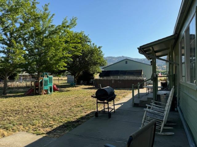 view of patio featuring a grill and a playground