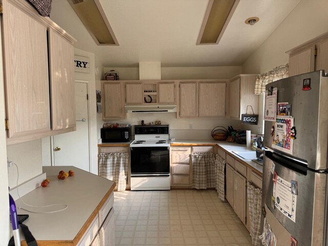 kitchen featuring freestanding refrigerator, black microwave, electric range, under cabinet range hood, and light brown cabinets