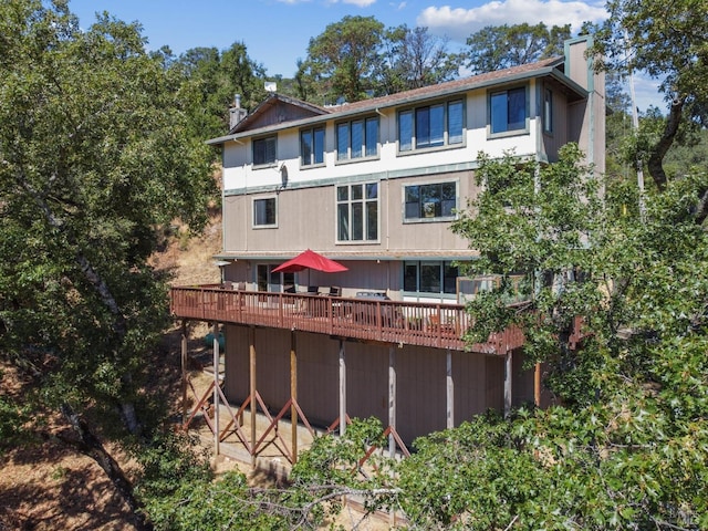 back of property with a wooden deck