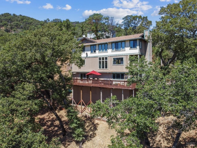 back of house featuring a wooden deck