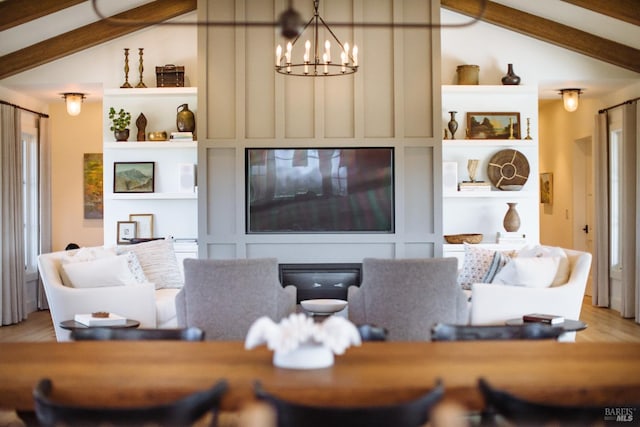 living room featuring hardwood / wood-style floors, vaulted ceiling with beams, and a chandelier