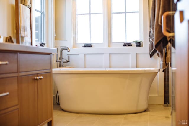 bathroom with vanity, a tub to relax in, and tile patterned floors