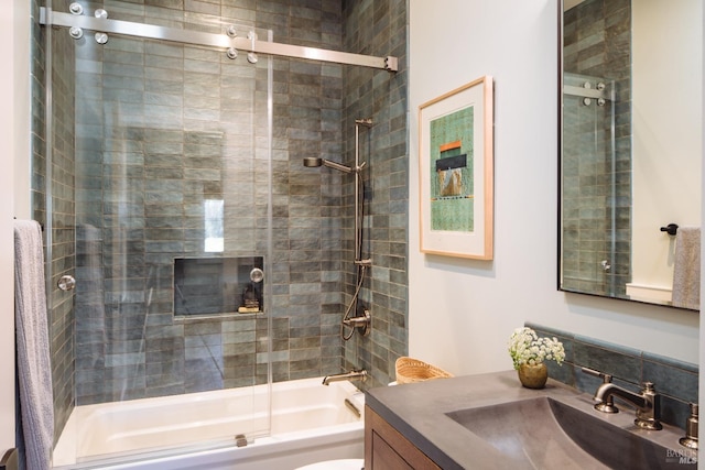 full bathroom with shower / bath combination with glass door, vanity, and toilet