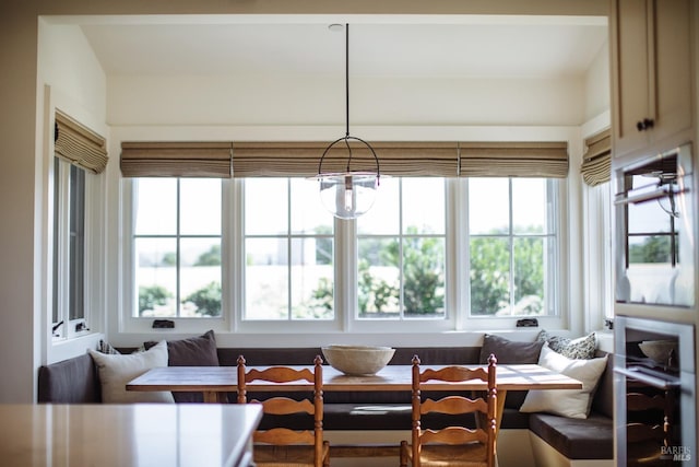 sunroom with breakfast area, a chandelier, and a wealth of natural light